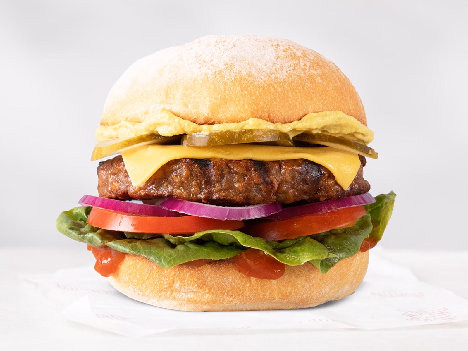 Grill’d Beyond Burger IV served in a bun with fresh lettuce, tomato, and vegan toppings