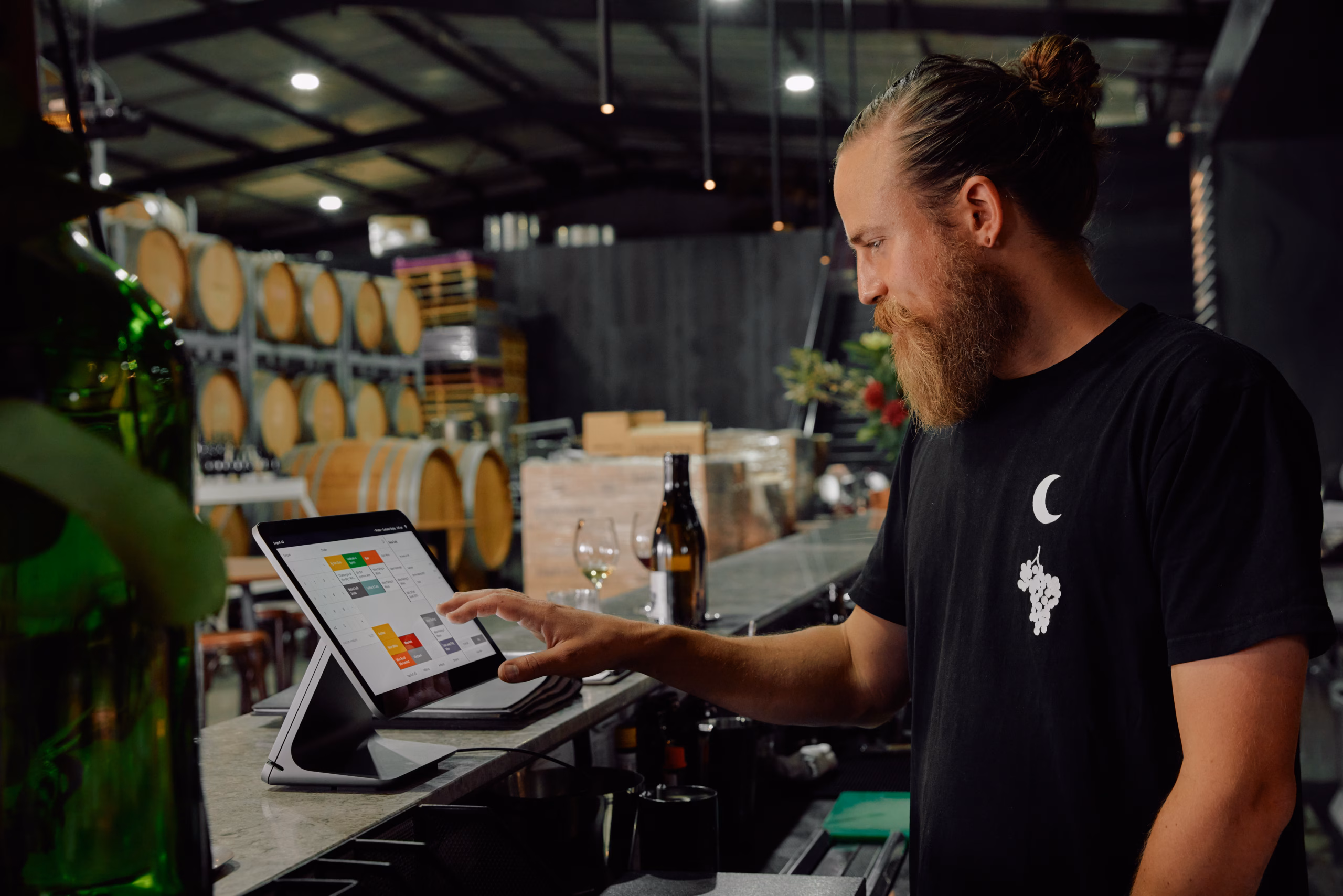 Jayden Ong serving wines using the Square point-of-sale system in a winery setting